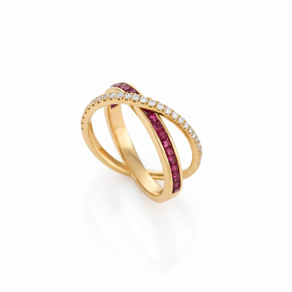 Gold ring with ruby criss cross and diamonds on a white background