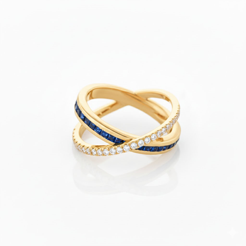 Gold criss cross ring with sapphires and diamonds on a white background