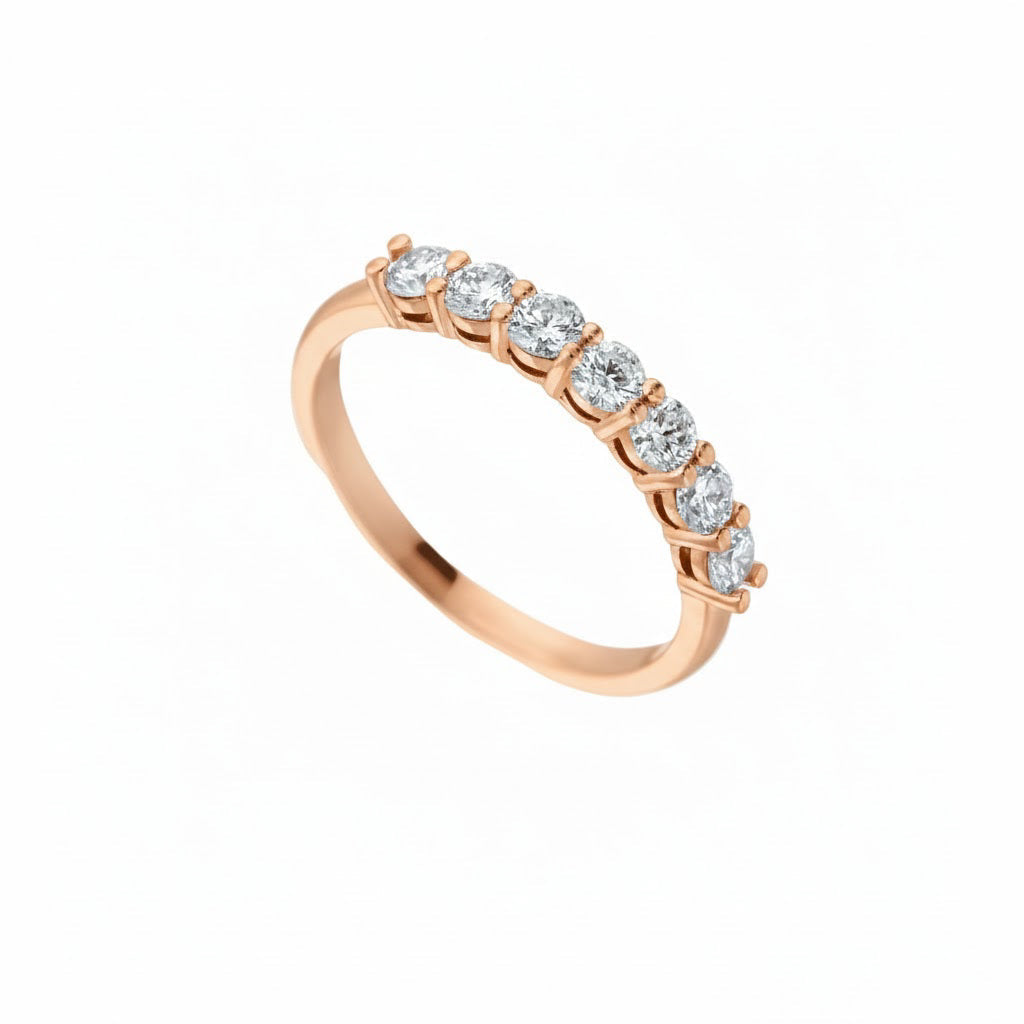 Seven stone round brilliant diamond eternity ring in rose gold setting.