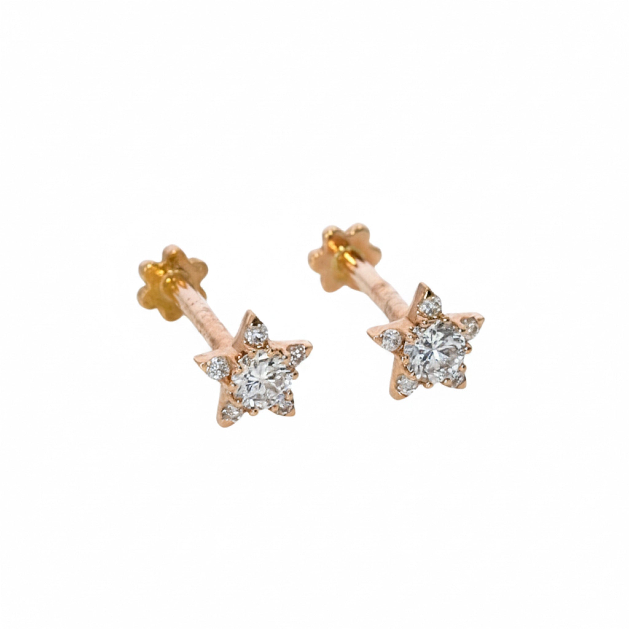 Star-shaped earrings in rose gold with diamonds on a white background