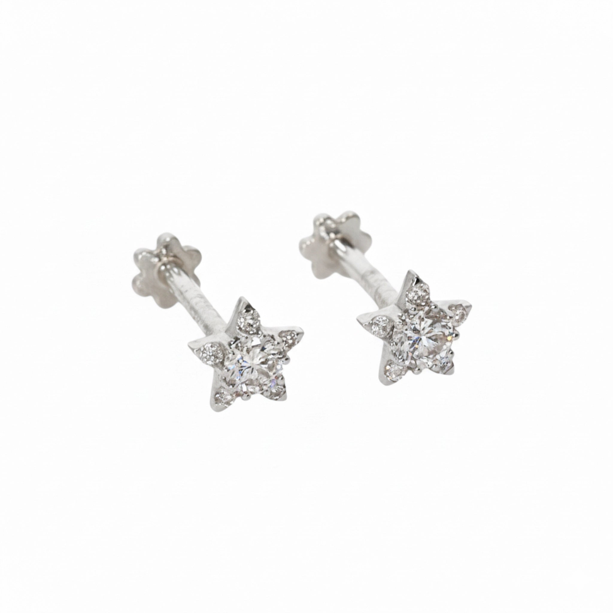 Star-shaped earrings with diamonds on a white background
