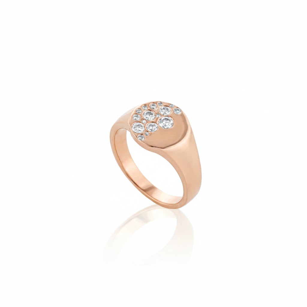 Rose gold ring with embedded diamonds on a white background