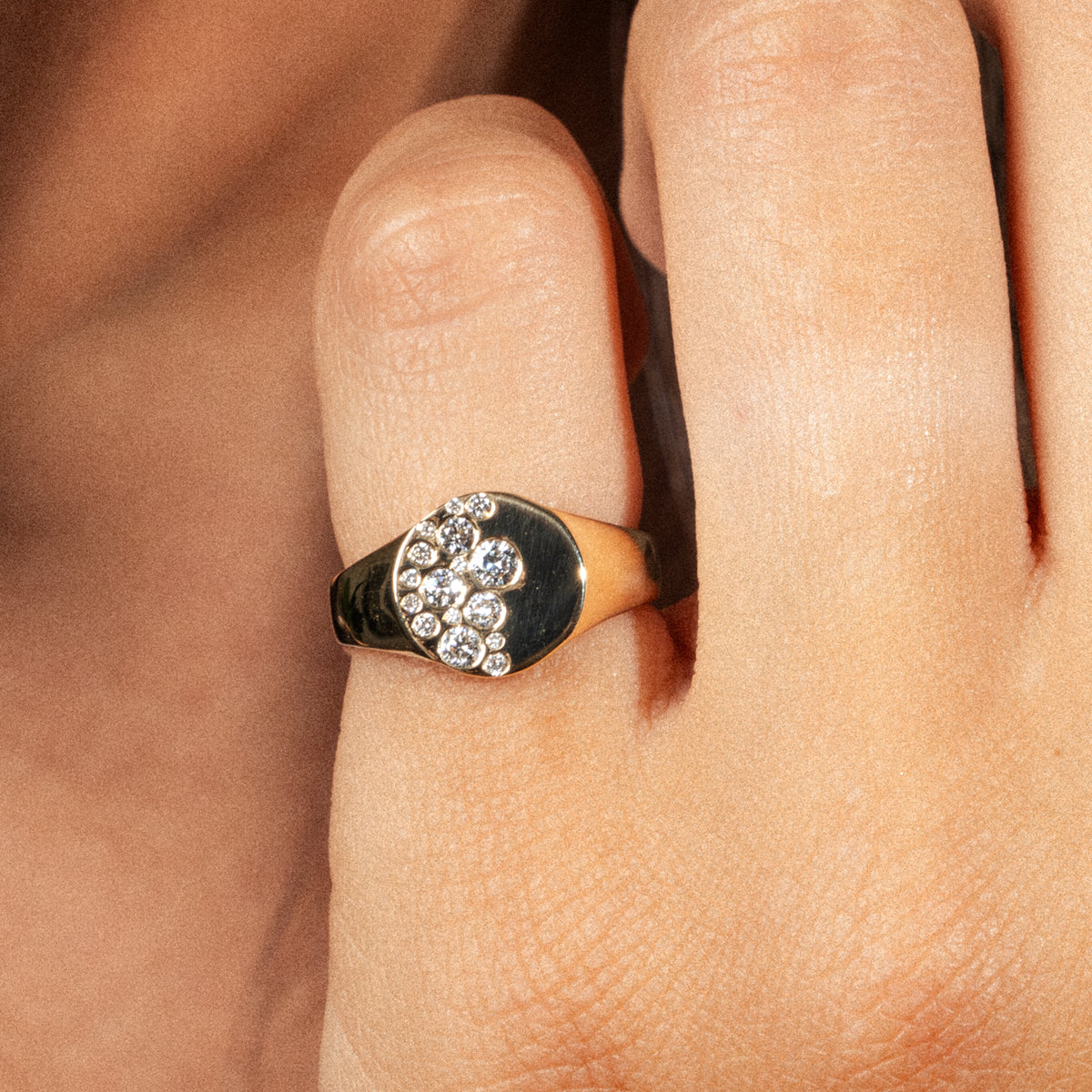 Sprinkle Ring featuring diamonds on a woman's pinky finger, showcasing elegance and modern design.