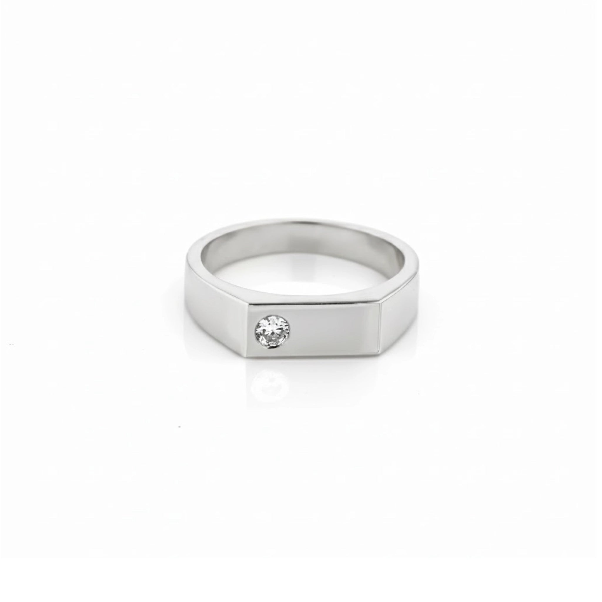 white gold signet ring with a diamond on a white background