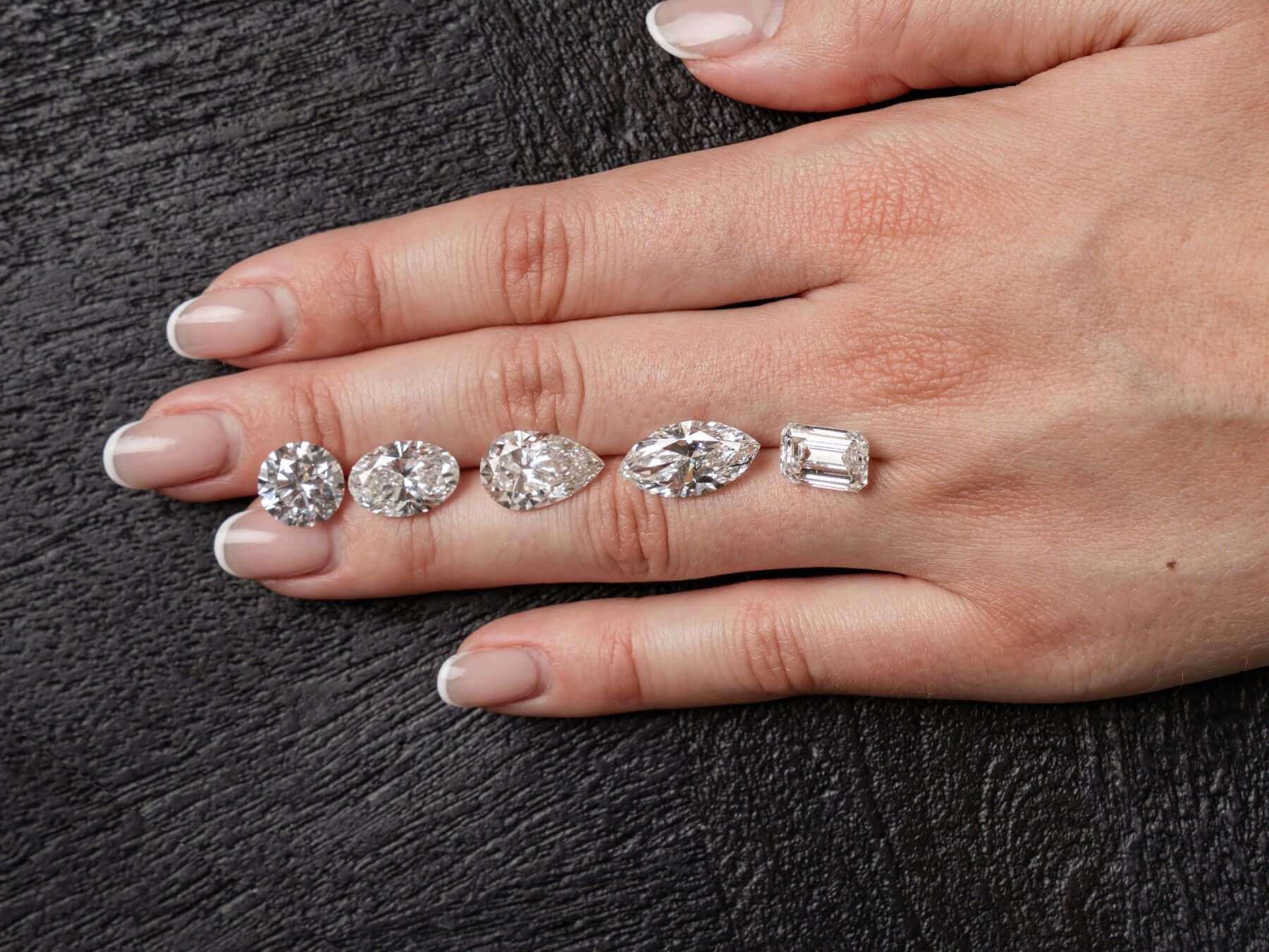 Various diamond shapes displayed on a hand, showcasing popular diamond jewellery styles.