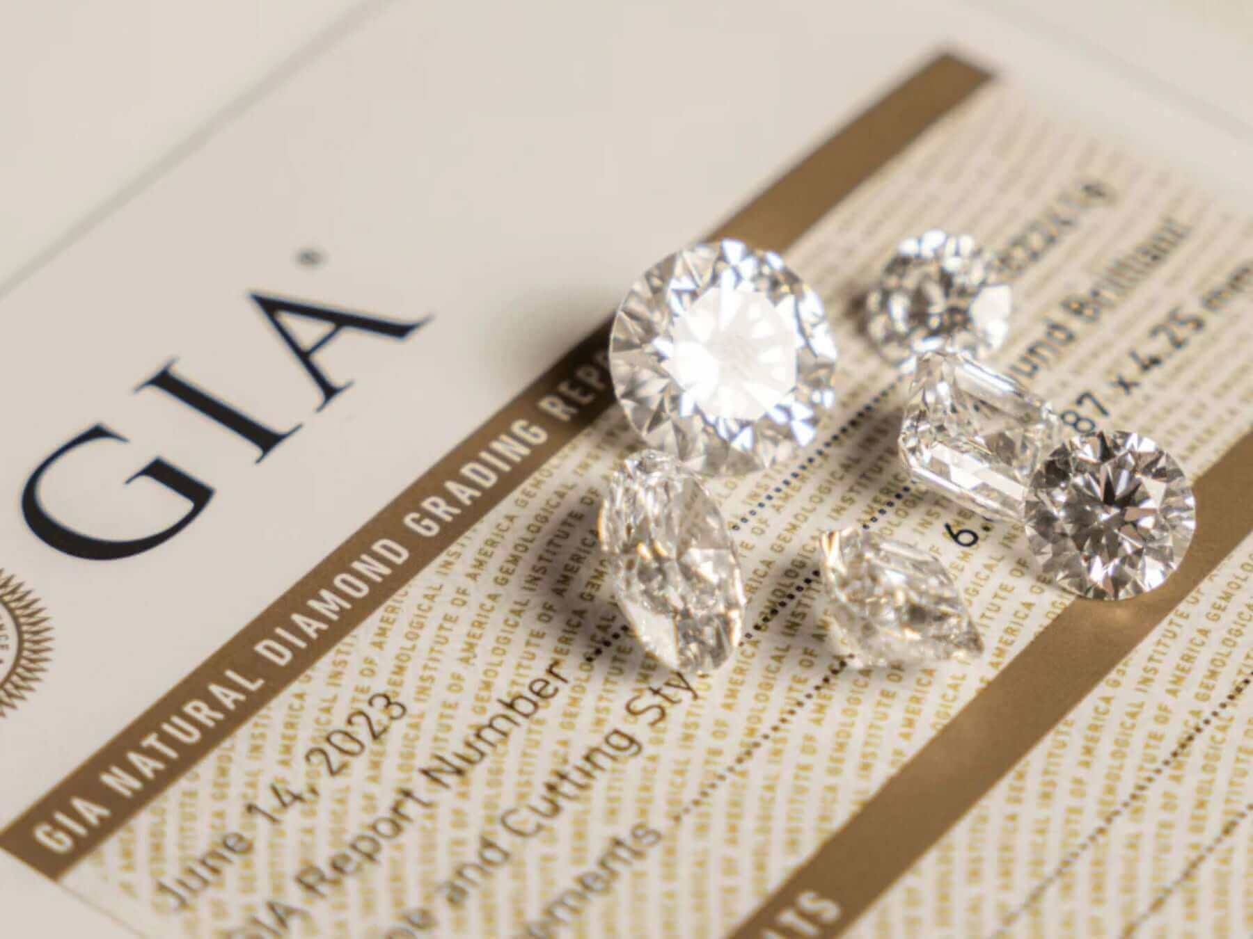 Collection of GIA graded diamonds showcasing various shapes on a grading report for diamond jewellery.