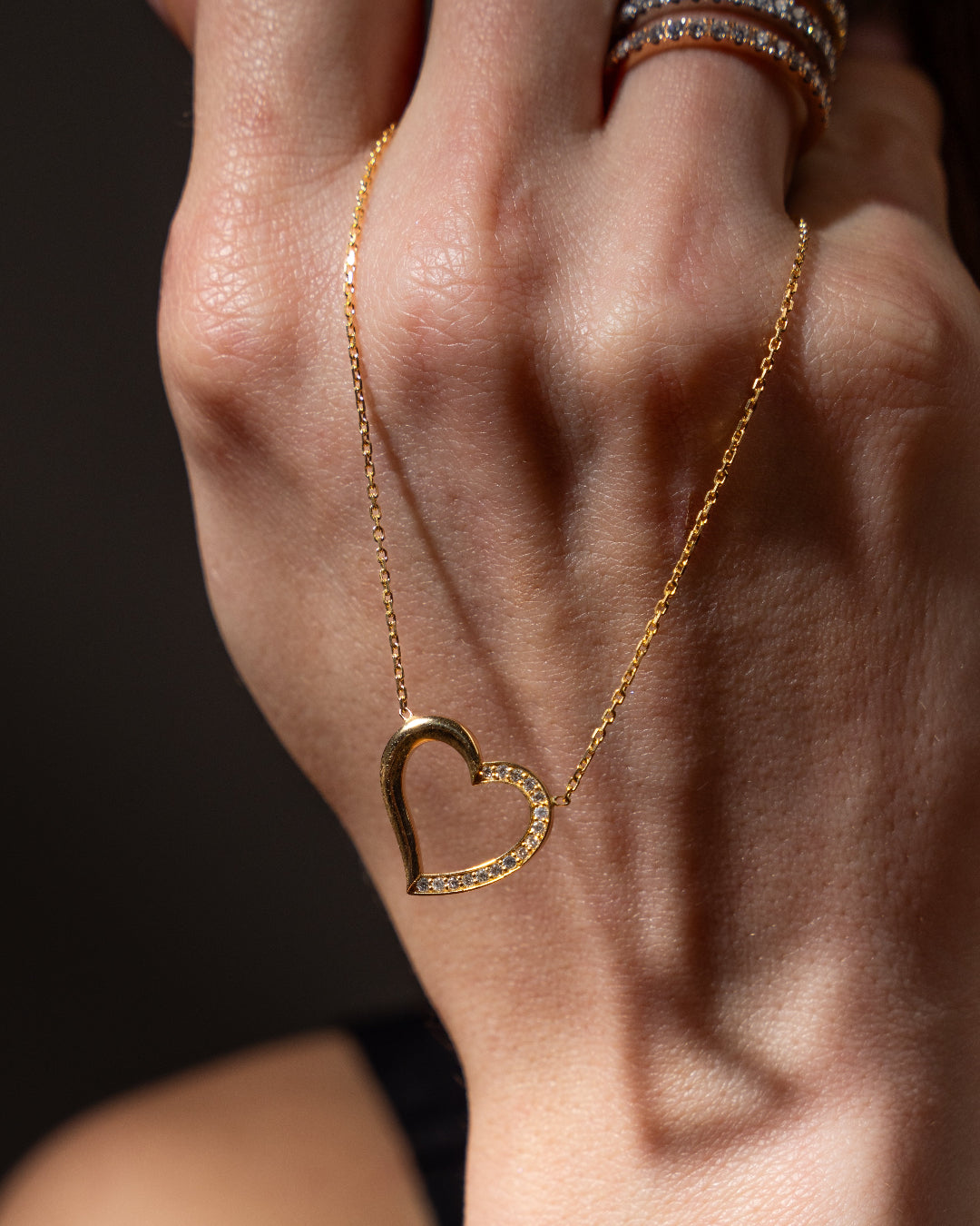 Elegant 18ct gold heart necklace with diamonds, showcasing artistic charm and modern design.