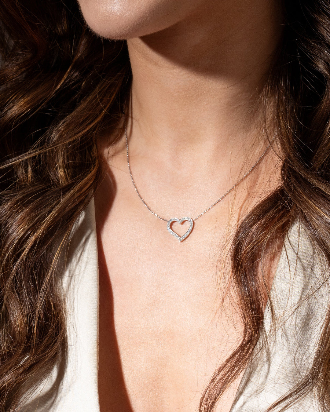 Amélie diamond necklace in 18ct gold worn by a model, showcasing a heart pendant with brilliant sparkle.