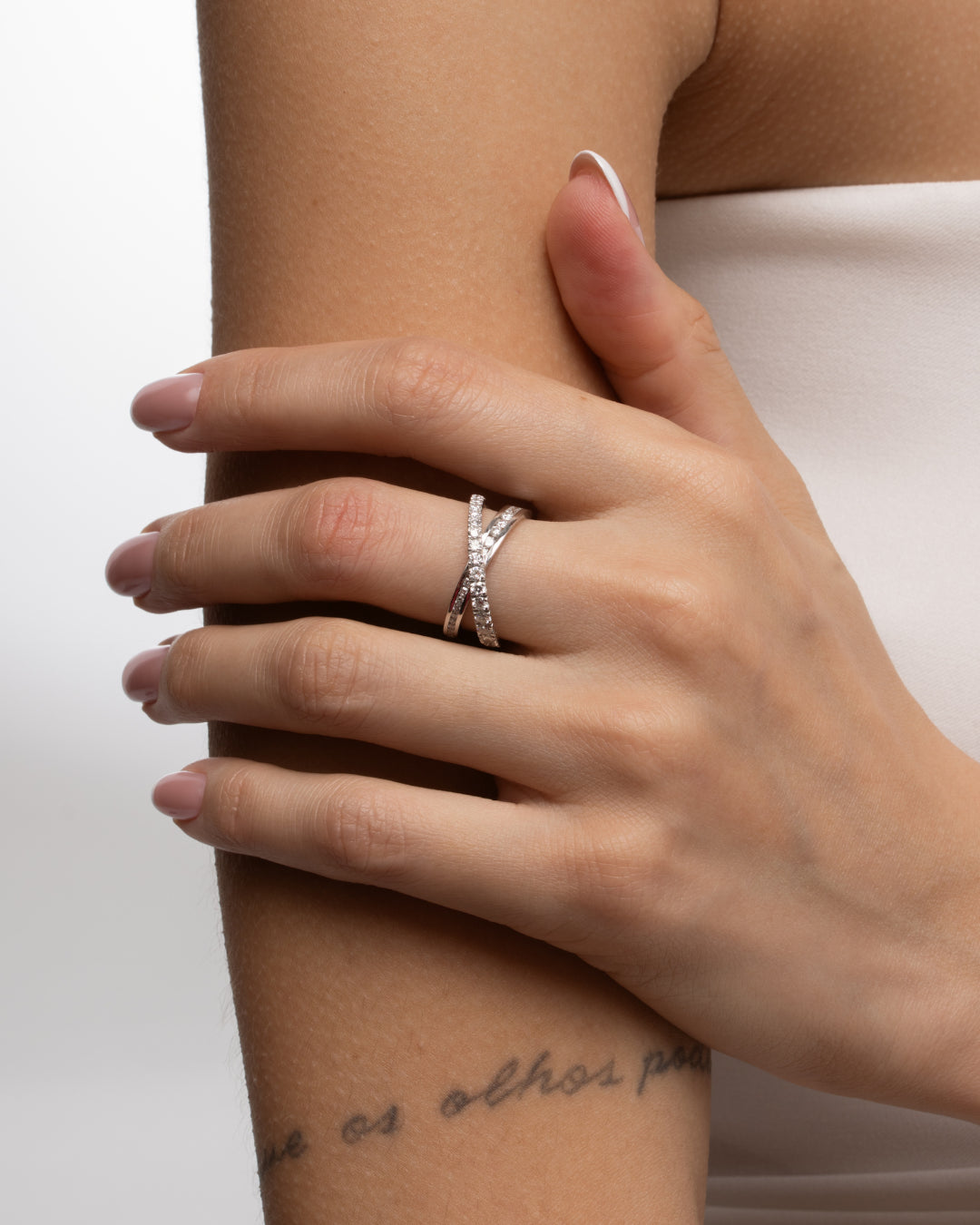 Coco Criss Cross Ring featuring certified  diamond rings on a woman's hand with an elegant design.