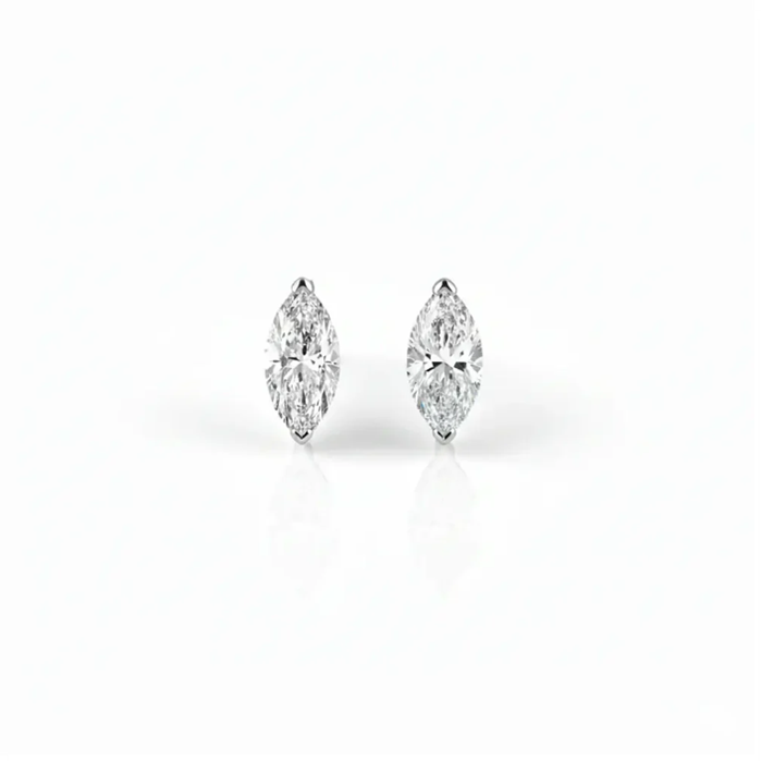 Pair of marquise-shaped diamond earrings on a white background