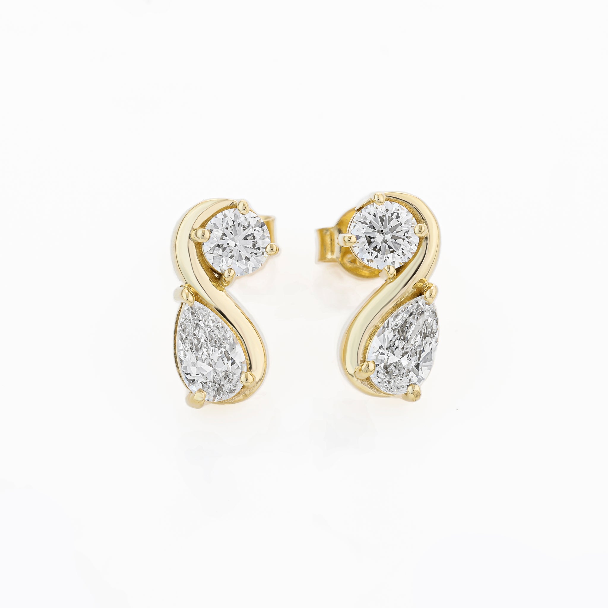 Yellow Gold earrings with pear shaped diamonds on a white background