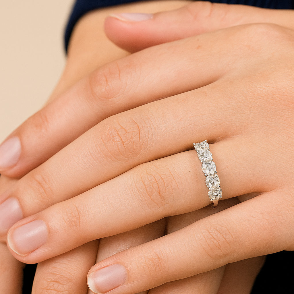 Close-up of a hand wearing a diamond eternity ring with Five Stone Eternity Ring with five brilliant cut diamonds