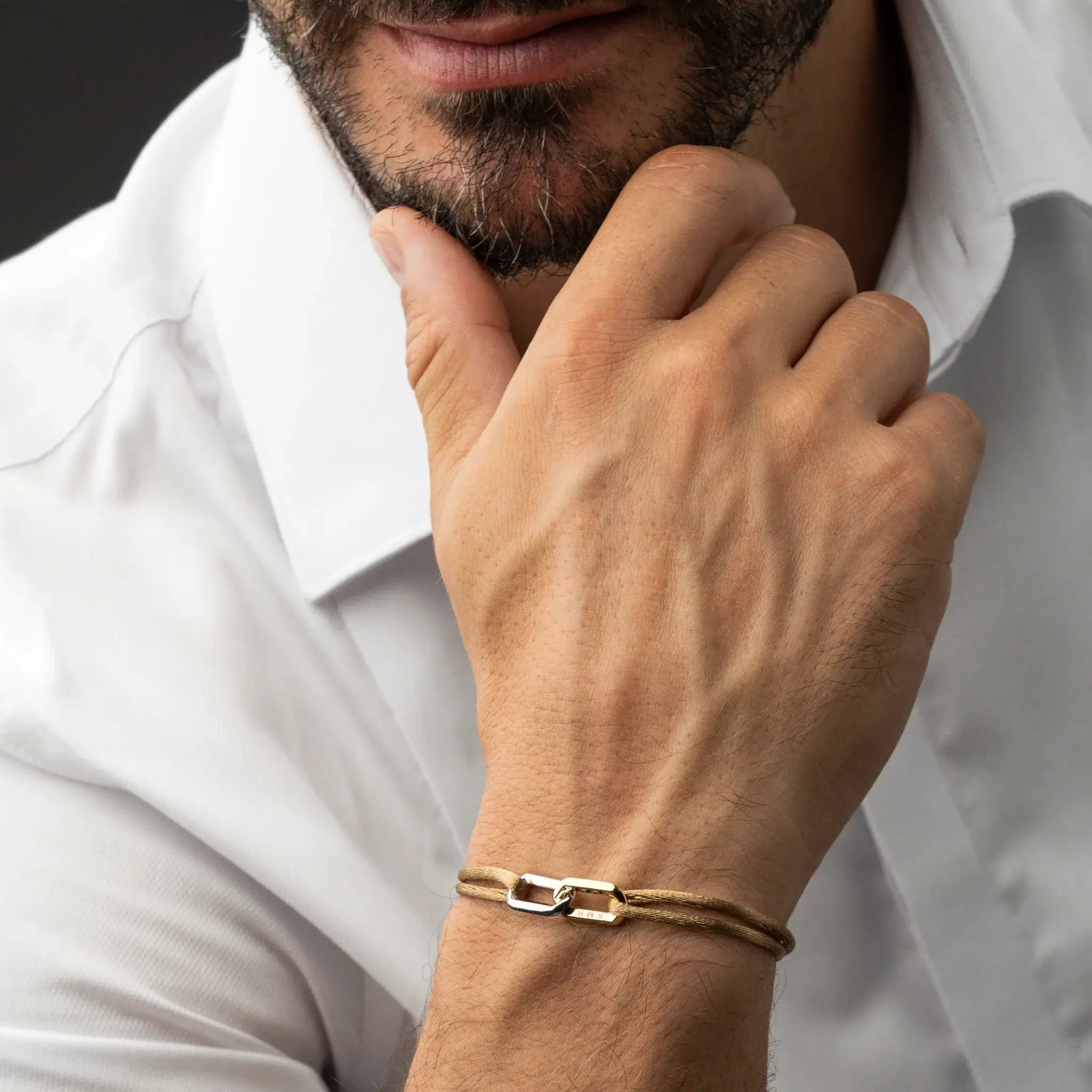 Man model wearing personalized bracelet with engraving and gemstones