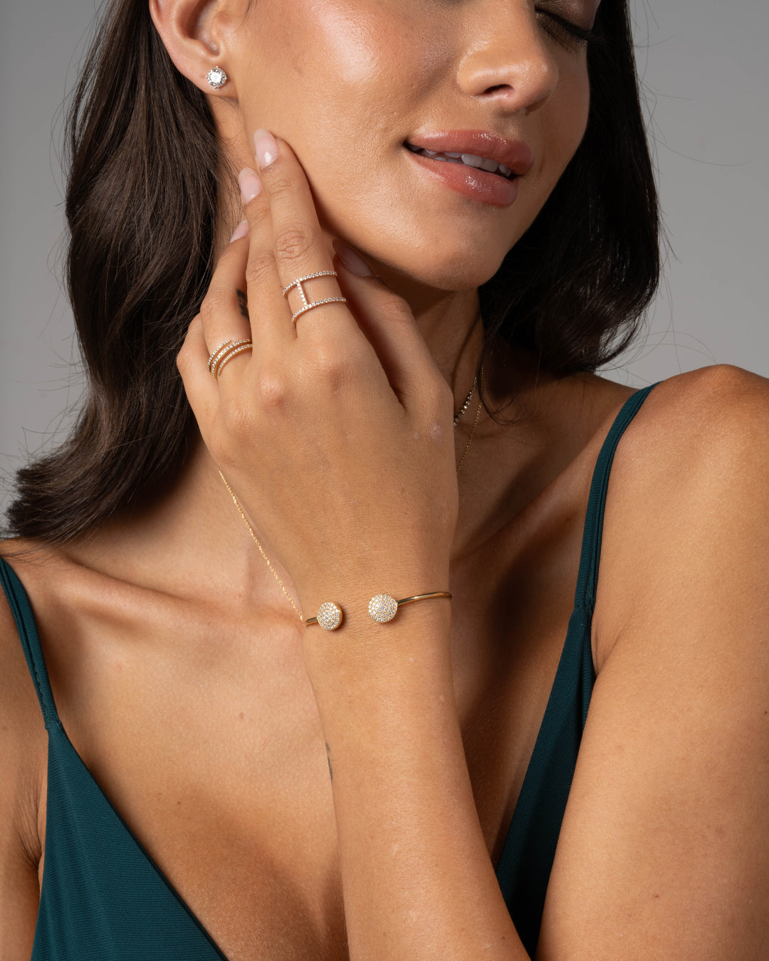 Elegant model showcasing a certified diamond bracelet and rings, radiating sophistication with sparkling accessories.
