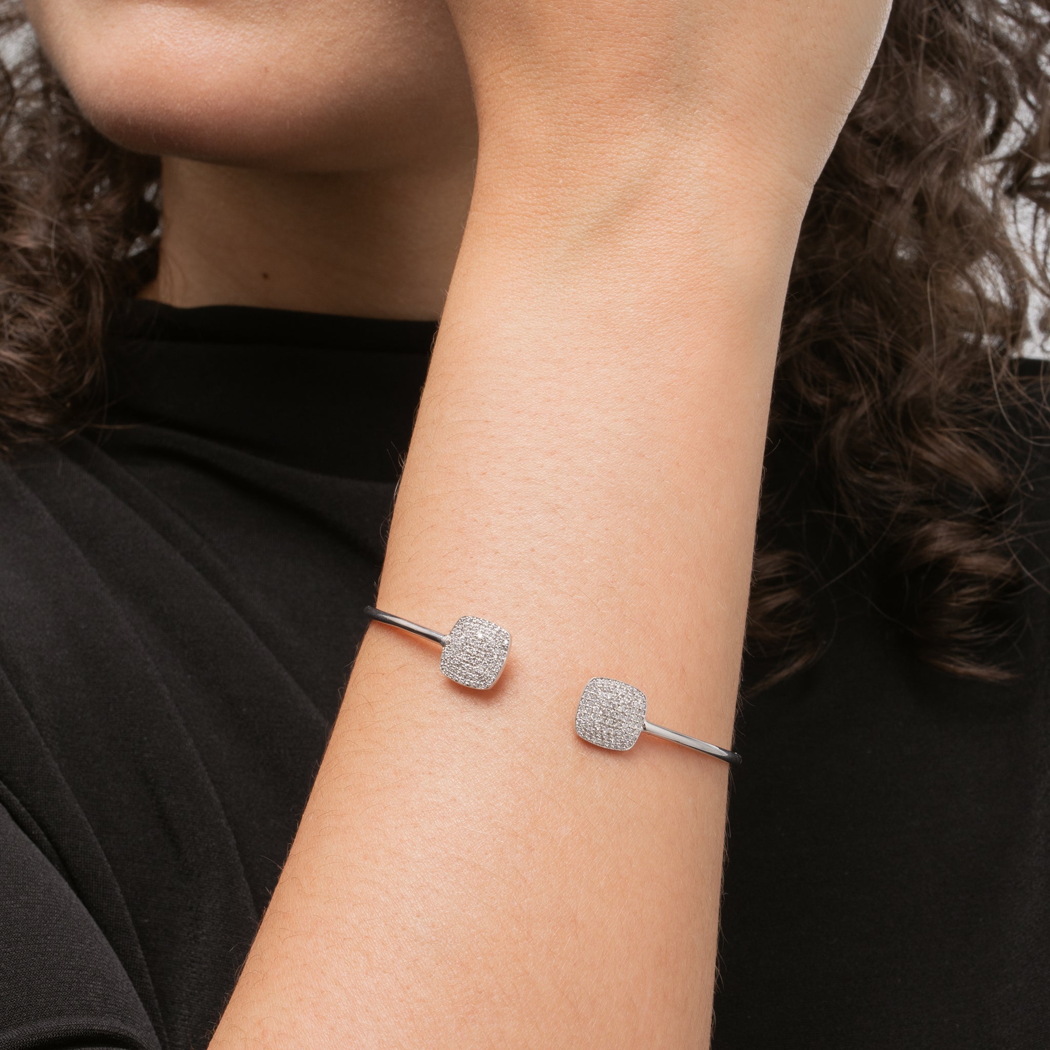 Elegant Gemini bangle featuring certified diamonds showcasing soft squares on a wrist, crafted in gold.
