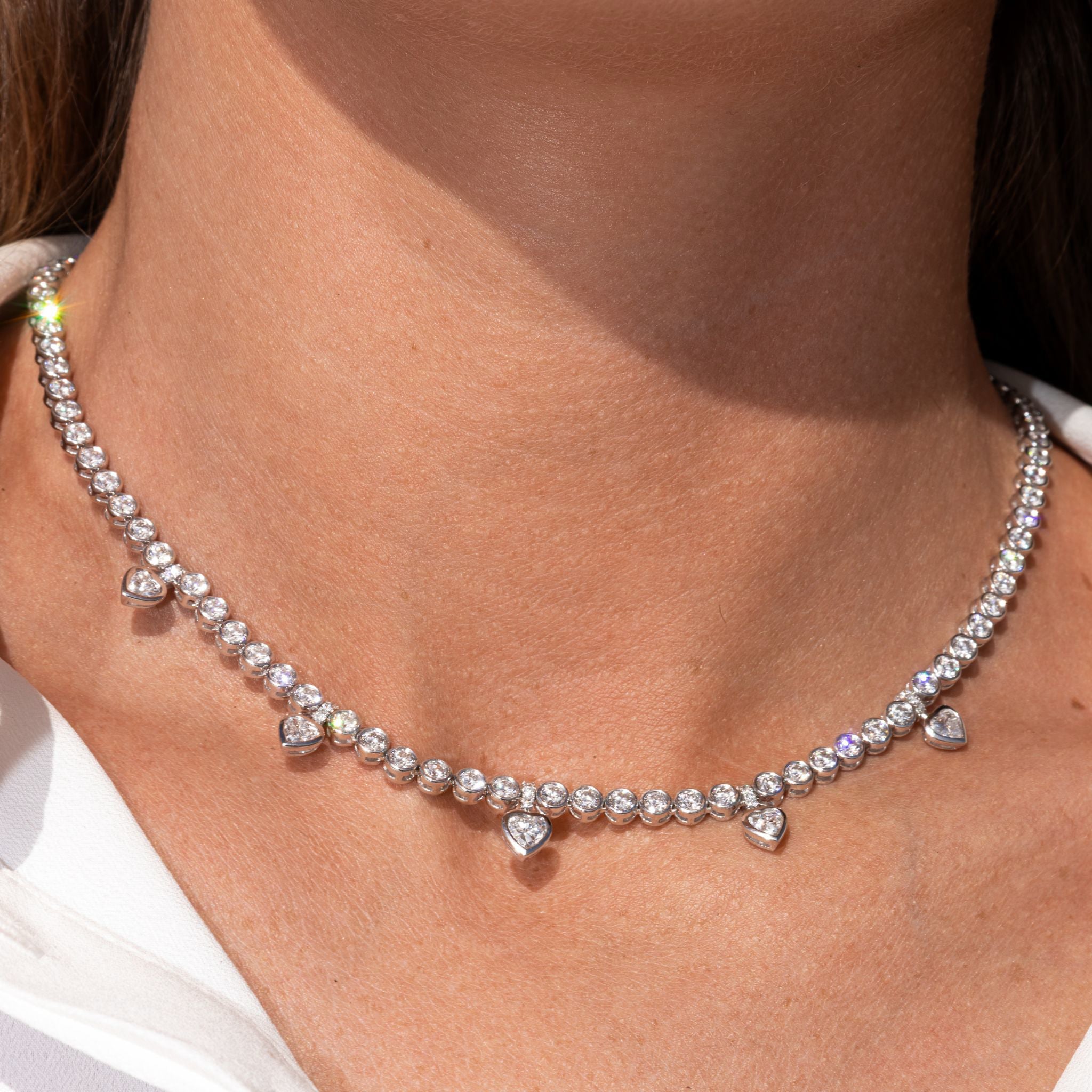 Heart Shape Diamond Tennis Necklace featuring round and pear shape diamonds with heart shaped dangles.
