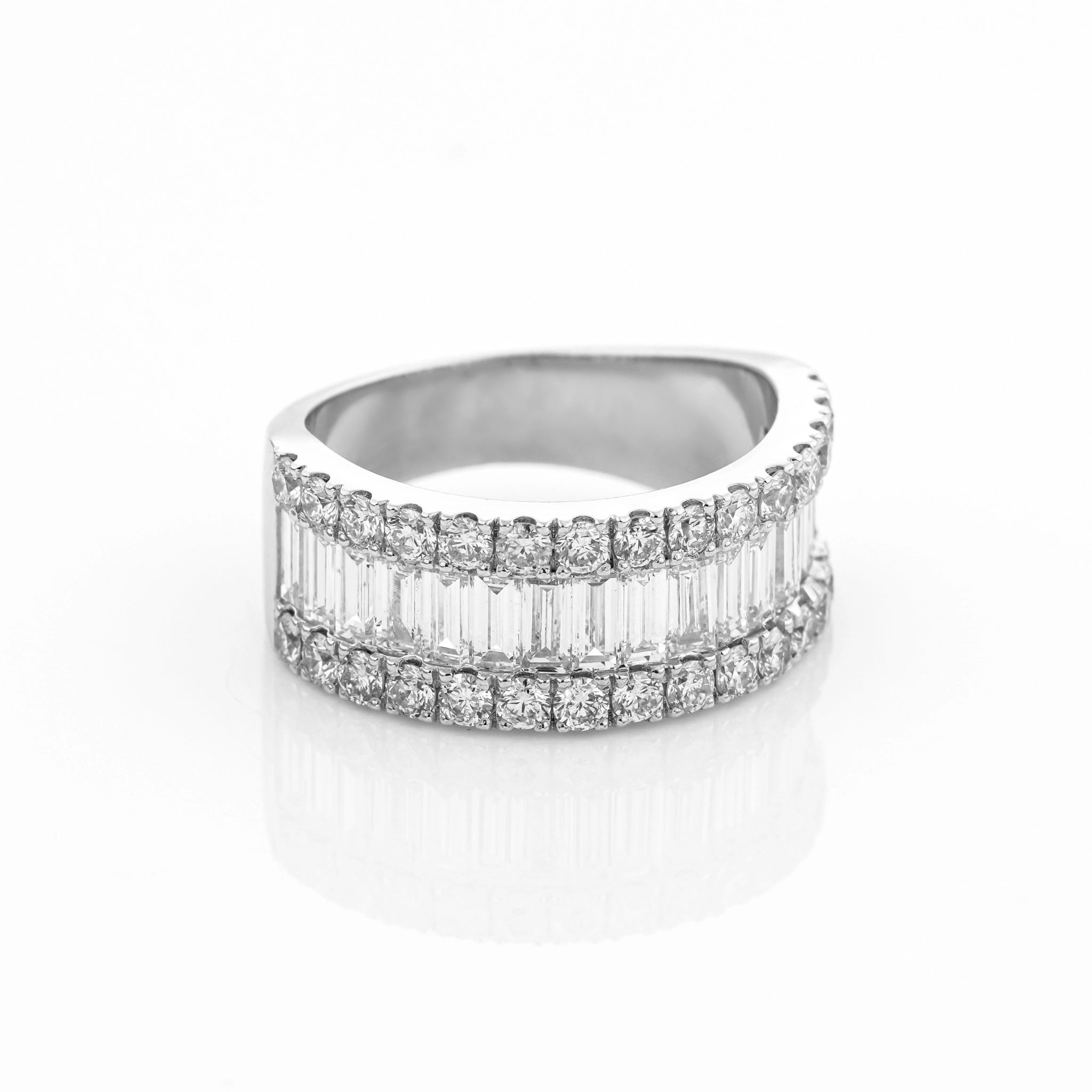 Diamond ring with baguette and round cut stones on a white background