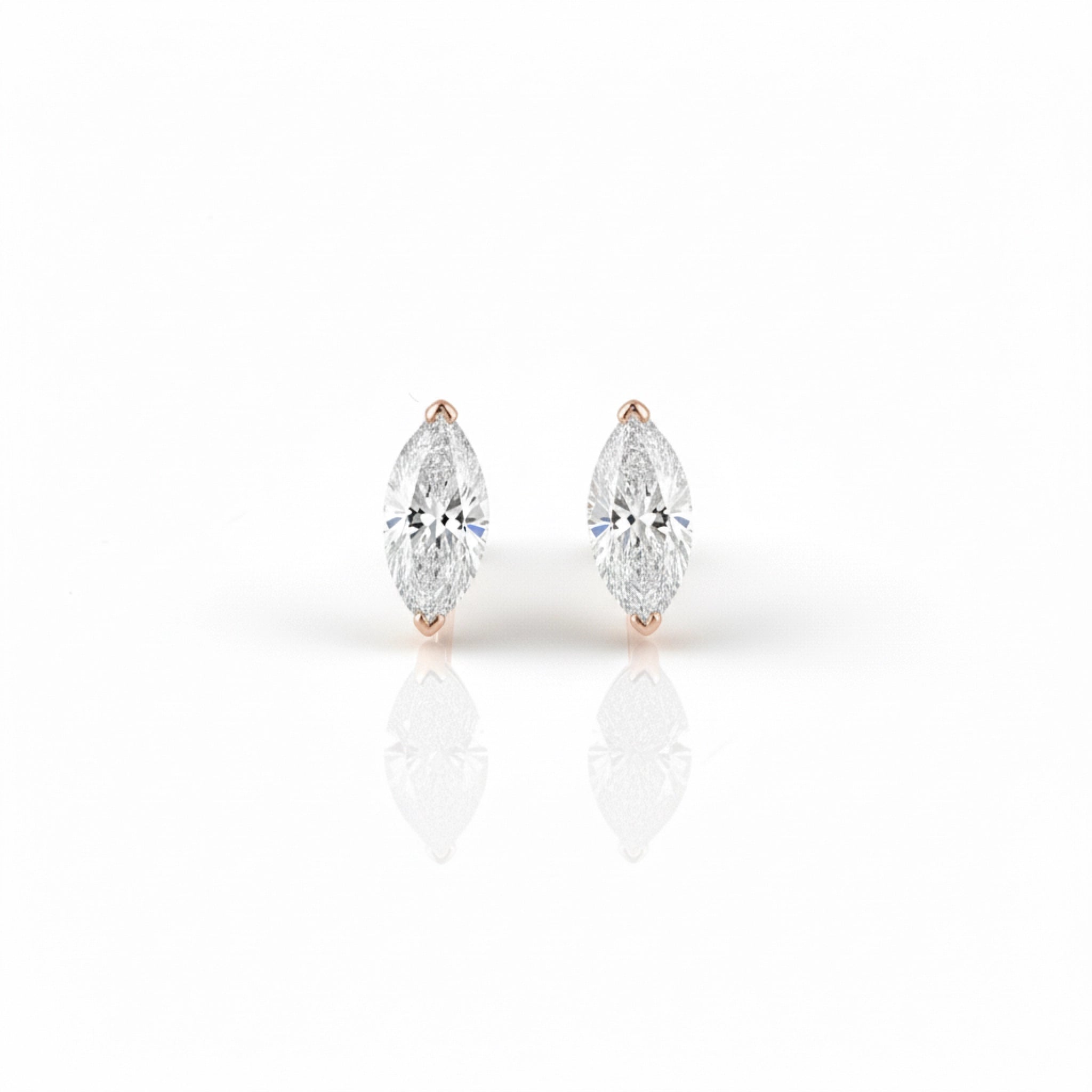 Pair of rose gold diamond stud earrings on a white background