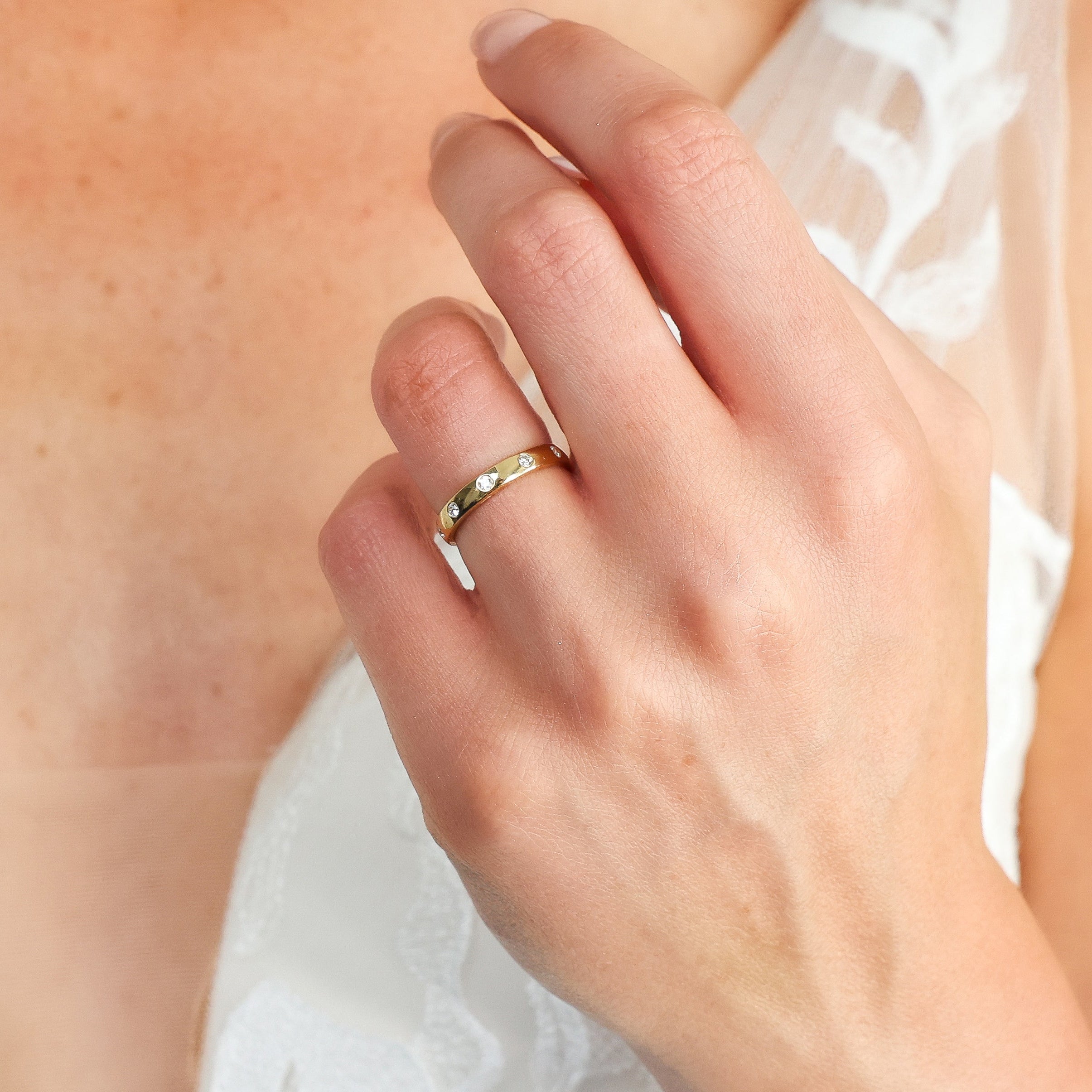 Round Brilliant Cut Diamond Inlay Band worn on hand, showcasing the elegant design and flush set diamonds.