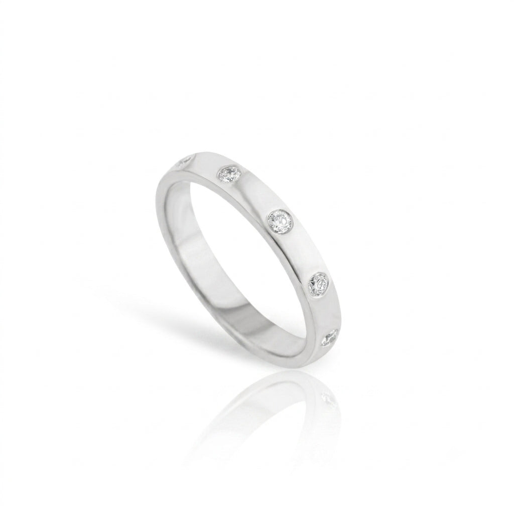 Round Brilliant Cut Diamond Inlay Band featuring flush set diamonds on a polished gold band.