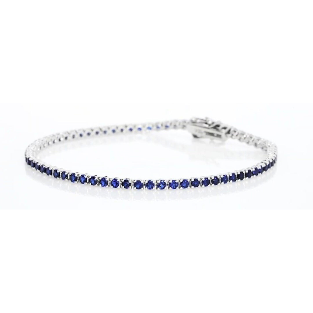 Sapphire tennis bracelet set in 18ct white gold showcasing exquisite violet-blue sapphires from our gemstone tennis bracelet collection.