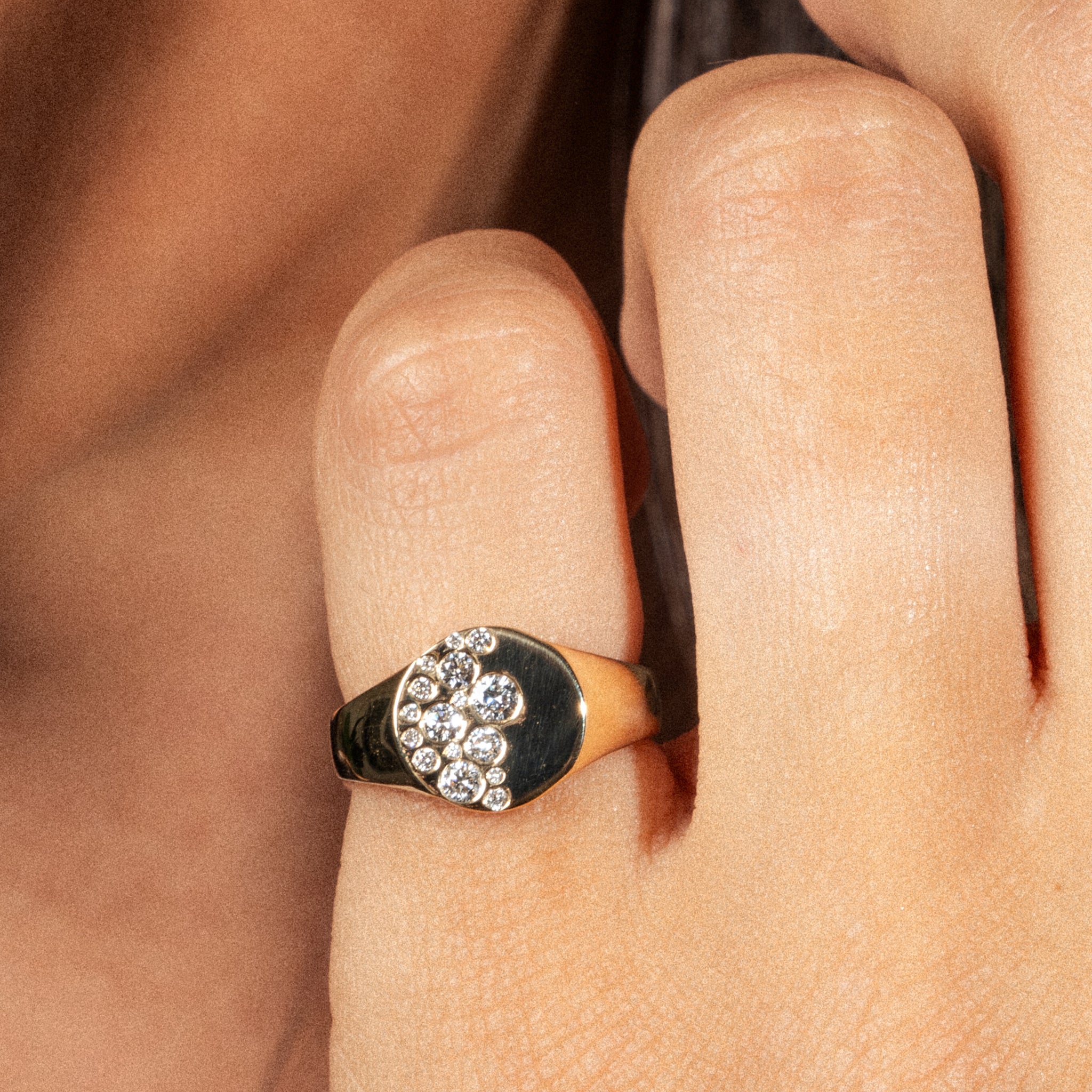 Sprinkle Ring featuring diamonds on a woman's pinky finger, showcasing elegance and modern design.