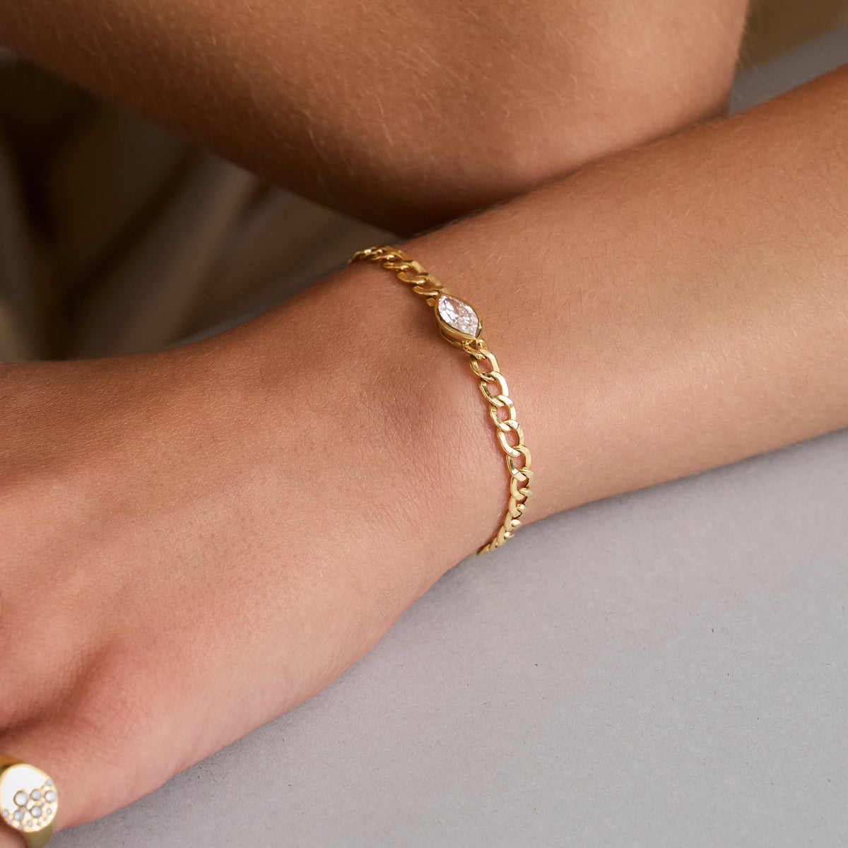 Gold Chain Link Bracelet Marquise elegantly worn on a wrist, featuring a marquise-cut diamond in a gold bezel.
