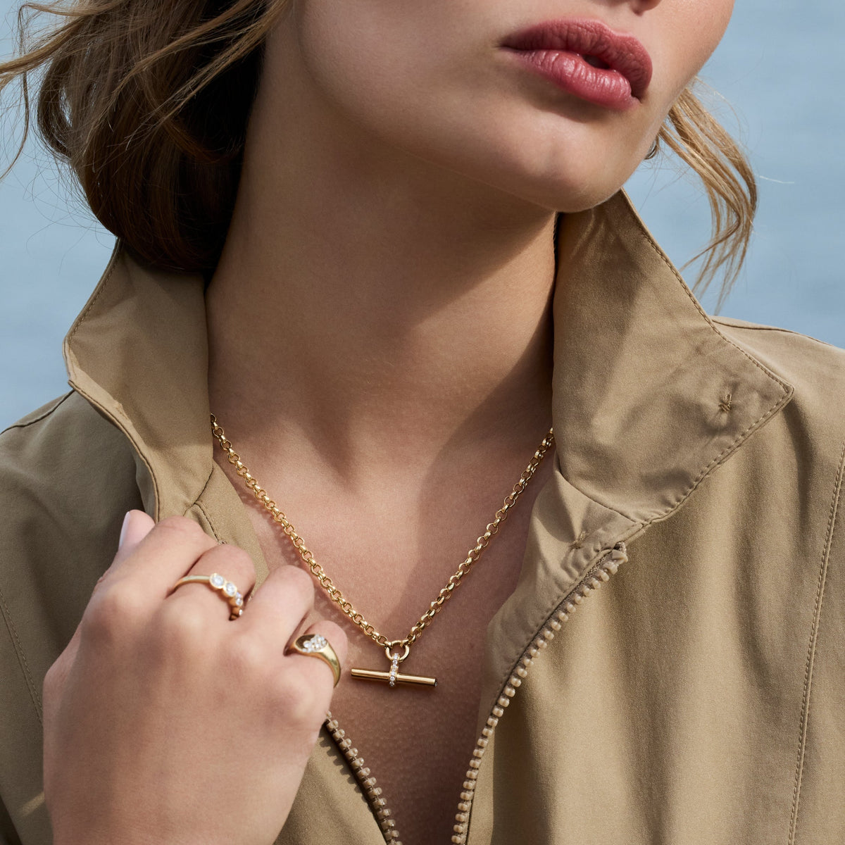 Model wearing a T Bar Necklace in gold with diamond accents, showcasing modern elegance and sophistication.