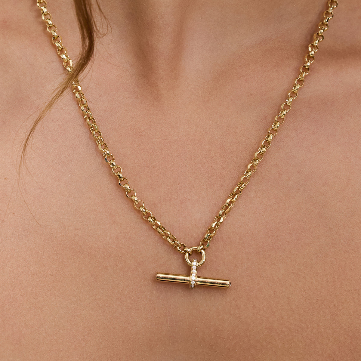 T Bar Necklace in yellow gold featuring a diamond accented pendant on a chain.