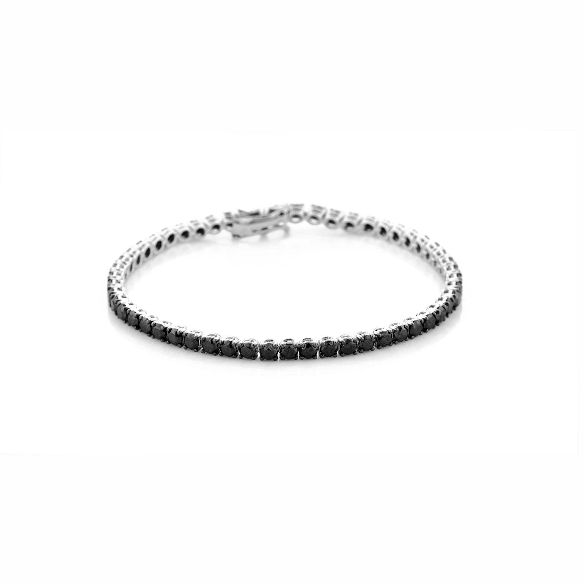 Black diamond tennis bracelet set in white gold on a white background