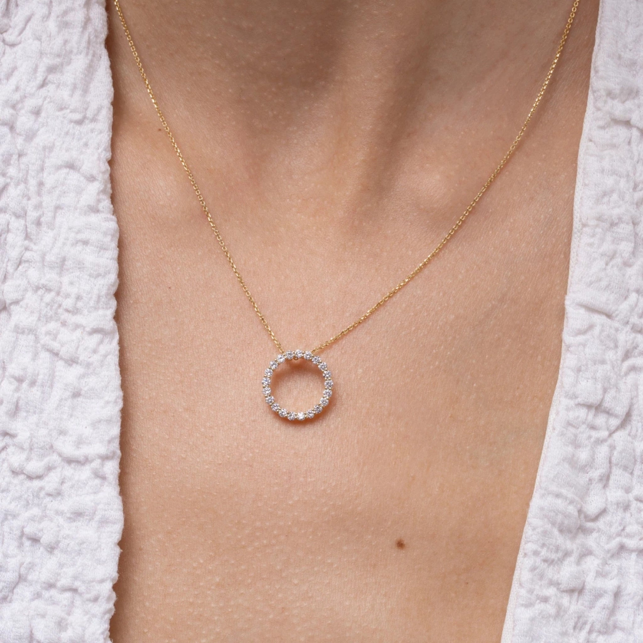 Close-up of the Circle Of Life Necklace - Small featuring brilliant diamonds on a delicate chain.