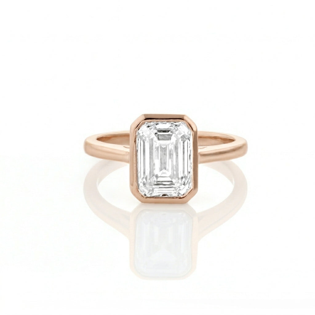 Bezel Set Emerald Cut Diamond Ring with a certificated diamond in rose gold colour