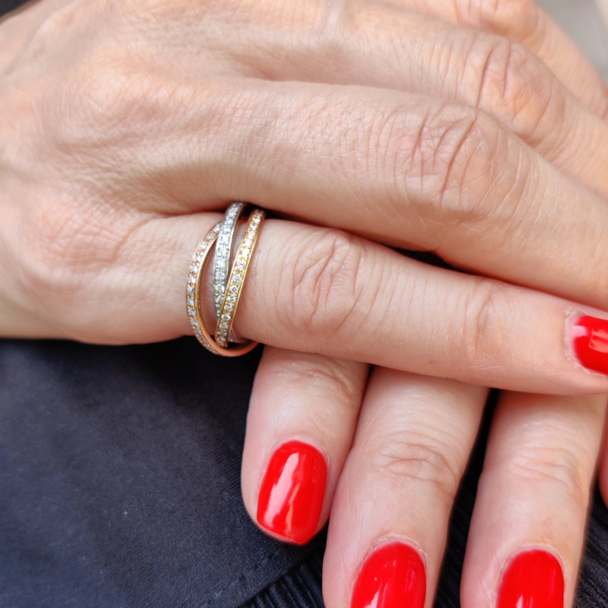 Model wearing grace diamond ring three rows of diamonds in 18ct white, rose, and yellow gold