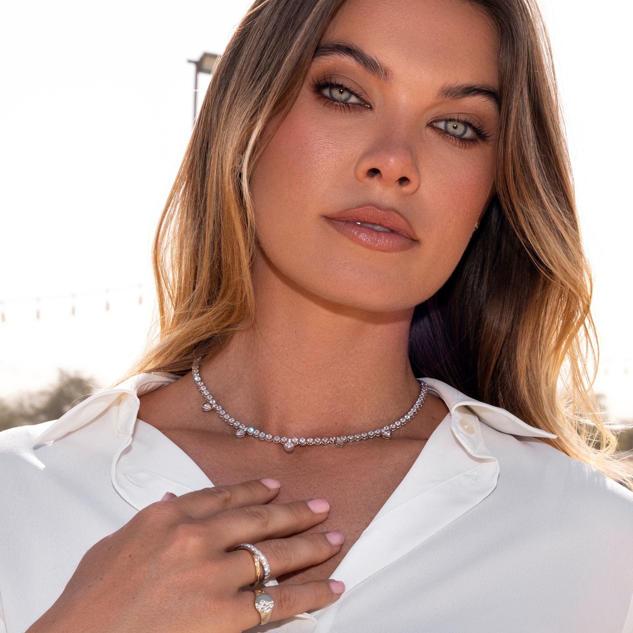 Heart Shape Diamond Tennis Necklace worn by a model, showcasing its stunning round and pear shape diamonds.