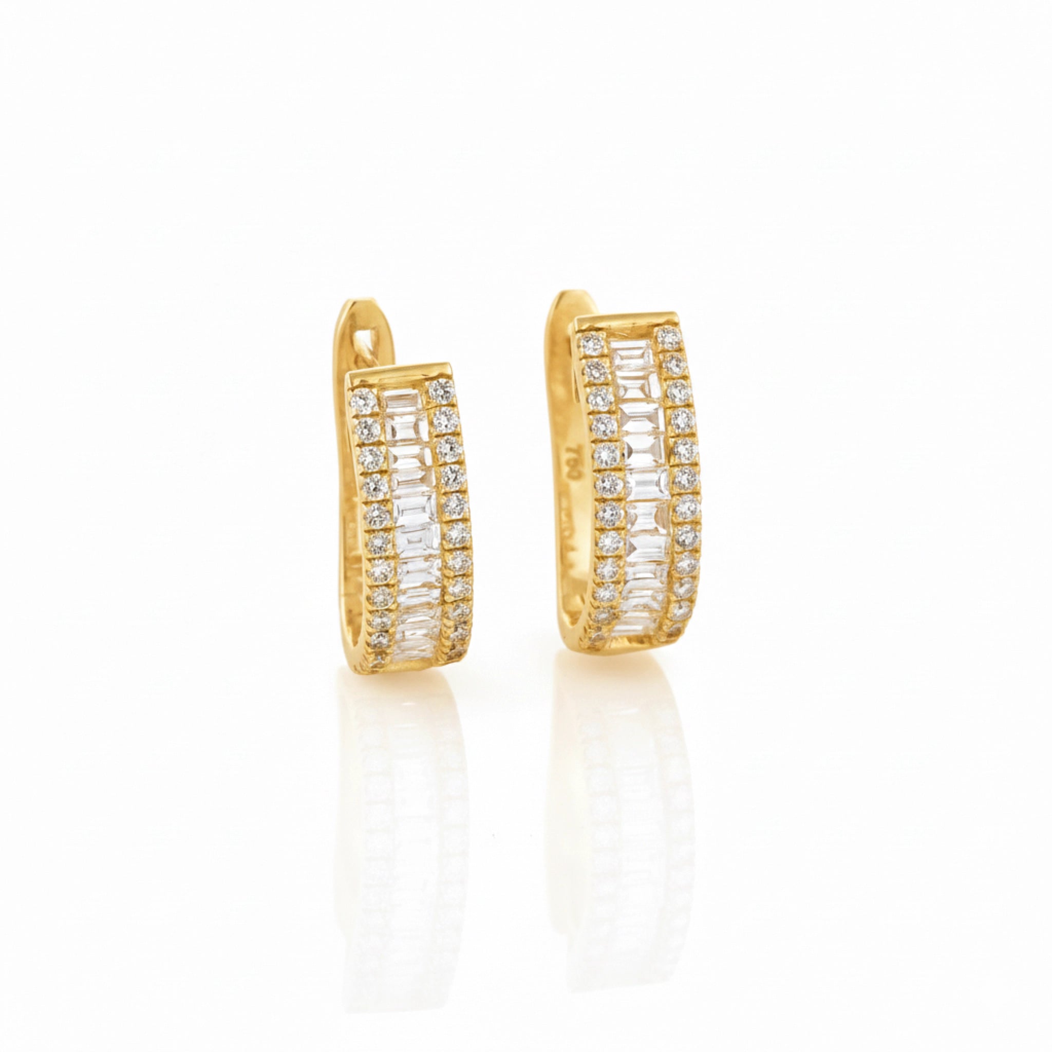 Gold hoop earrings with diamonds on a white background