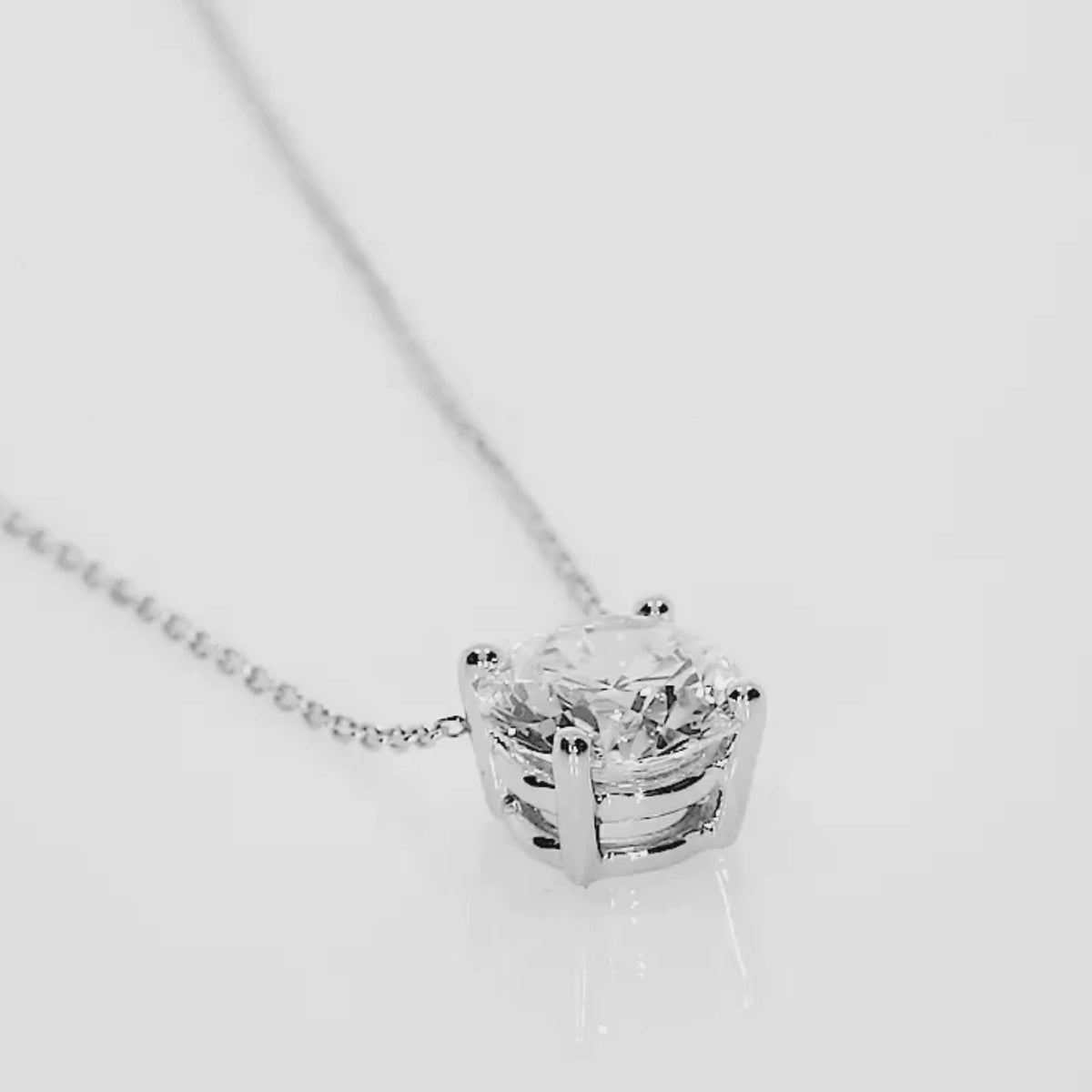 The Floating Diamond Necklace featuring a round brilliant cut diamond in a four claw setting on a fine gold chain.