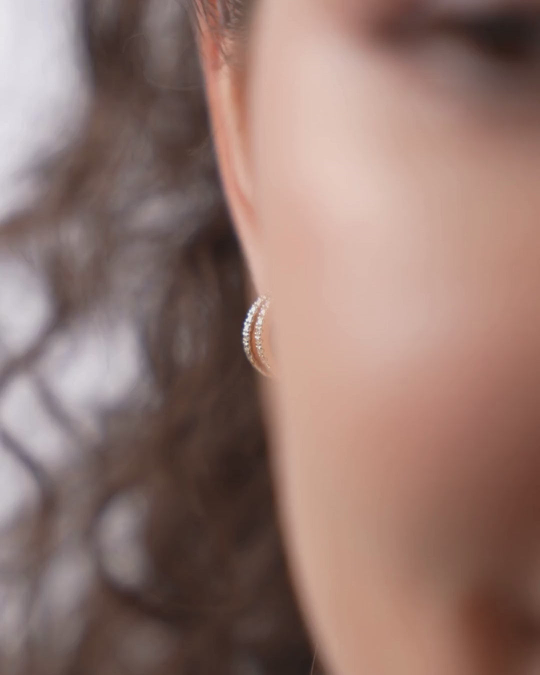 Close-up of double row diamond huggies highlighting certified diamond earrings in elegant 18ct gold setting.
