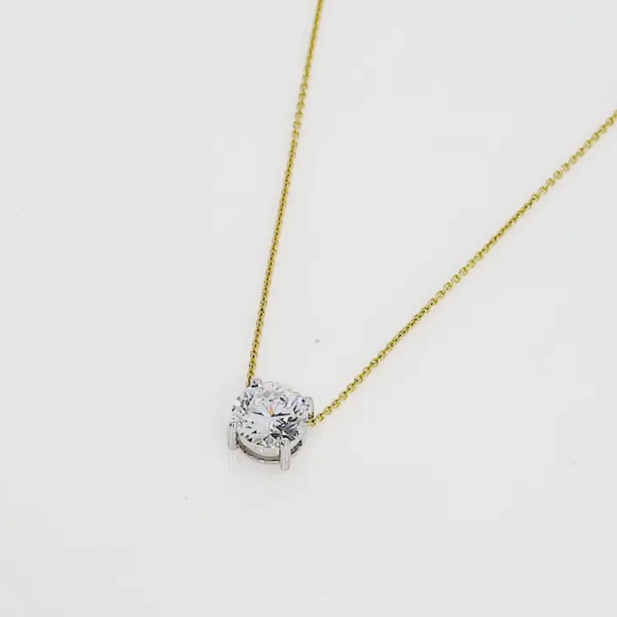The Floating Diamond Necklace featuring a brilliant cut diamond on an 18ct gold chain, symbolizing elegance and sophistication.
