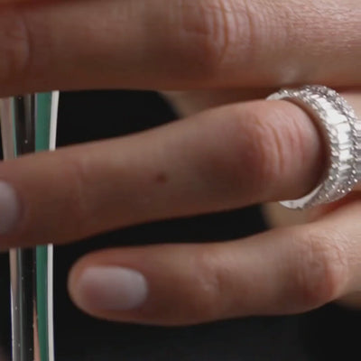 Close-up of a hand wearing a diamond eternity ring