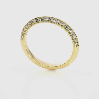 Knife Edge Wedding Band showcasing diamond accents set in gold, highlighting its elegant architecture and design.