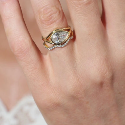 Pear Shaped Ring in gold setting, showcasing an elegant pear cut diamond with a unique design.