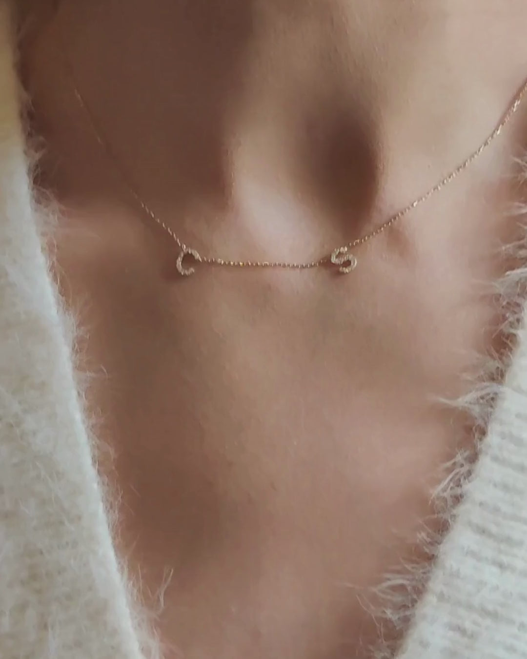 Close-up of a Love Letter necklace featuring hand-crafted initials with natural diamonds, worn on a delicate chain.