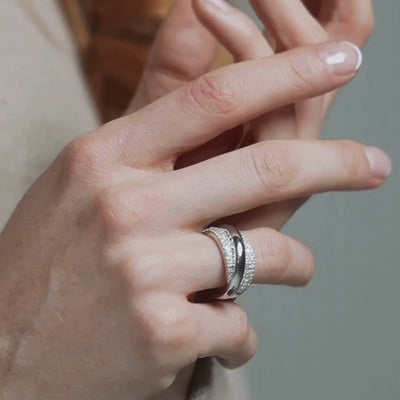 Model wearing multiple diamond rings and eternity rings