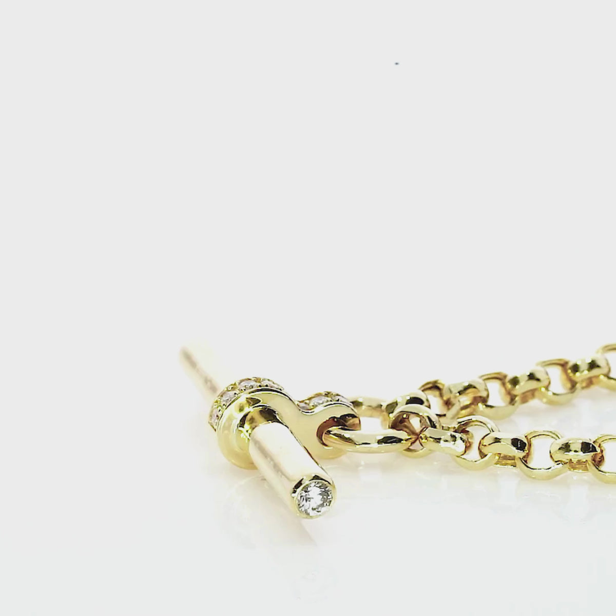 Close-up of T Bar Necklace in yellow gold with diamond accents and pavé detailing.