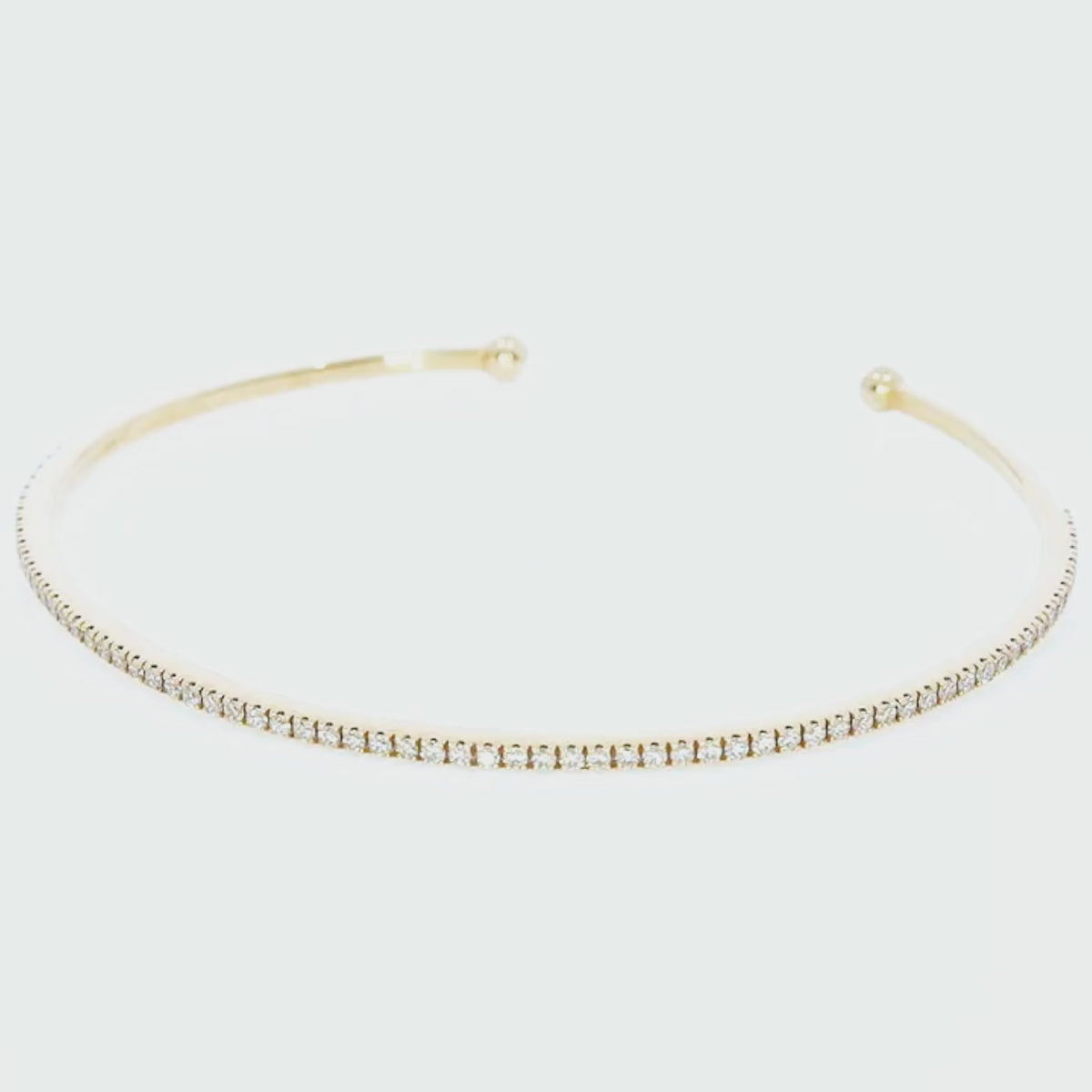 Elegant push-on tennis bangle set in 18ct gold with diamonds, a perfect accessory for a chic stack.
