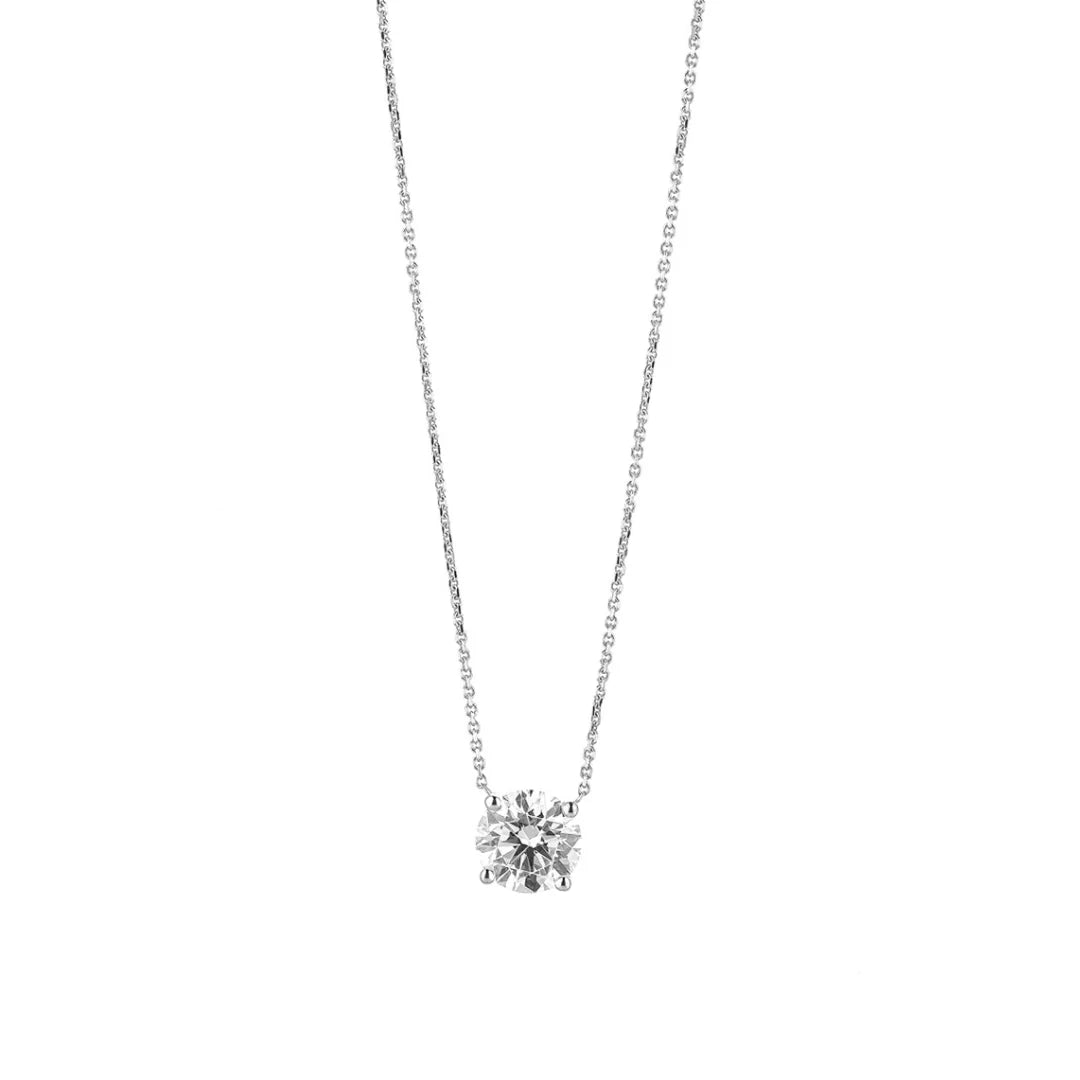 Elegant floating diamond necklace on fine chain, featuring a round brilliant cut diamond in four claw setting.